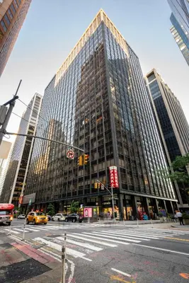 a tall building with windows on a city street at FiDi Studio w Work Setup by Anyplace - 11679 in New York