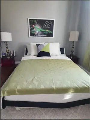 a large bed in a bedroom with two lamps at Belmont Place in Wilmington