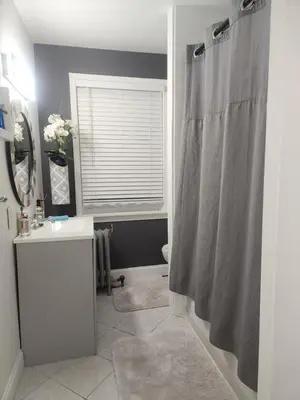 a bathroom with a shower curtain and a sink at Belmont Place in Wilmington