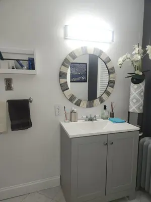 a bathroom with a sink and a mirror on the wall at Belmont Place in Wilmington