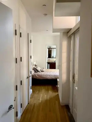 a bedroom with a bed in the middle of a room at Noho Luxury Building 1Br with Living room with Pool and First Floor in New York