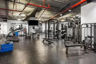a gym with several treadmills and machines at Noho Luxury Building 1Br with Living room with Pool and First Floor in New York