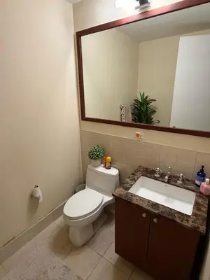 a bathroom with a toilet and a sink and a mirror at Noho Luxury Building 1Br with Living room with Pool and First Floor in New York