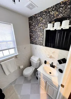 a bathroom with a white toilet and a sink at 30 min from NYC luxury and chic 3 bedroom in Harrison