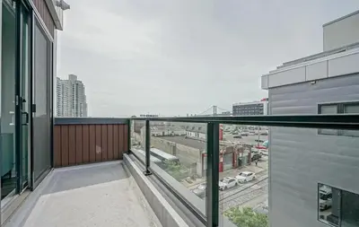 an apartment balcony with a view of a city at The Executive Penn's Landing - High End Luxury 3BR-Sauna-Gym-Garage-Roof Deck in Philadelphia