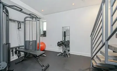 a fitness room with a gym with a treadmill at The Executive Penn's Landing - High End Luxury 3BR-Sauna-Gym-Garage-Roof Deck in Philadelphia