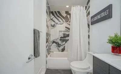a white bathroom with a toilet and a shower at The Executive Penn's Landing - High End Luxury 3BR-Sauna-Gym-Garage-Roof Deck in Philadelphia