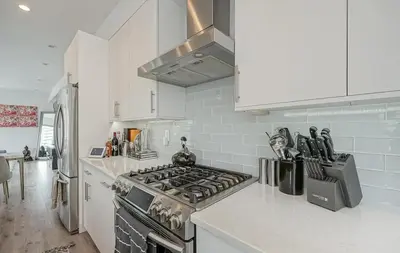 a kitchen with a stove and a counter top at The Executive Penn's Landing - High End Luxury 3BR-Sauna-Gym-Garage-Roof Deck in Philadelphia