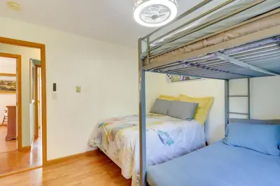 a bedroom with two bunk beds and a hallway at Game Room Retreat 5 Mi to Big Boulder Mtn in Blakeslee