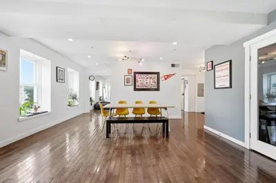 a living room with a table and yellow chairs at Beautiful 4th Floor Walk-Up Apartment in Old City in Philadelphia