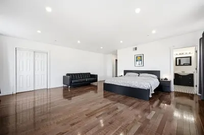 a large white bedroom with a bed and a couch at Beautiful 4th Floor Walk-Up Apartment in Old City in Philadelphia
