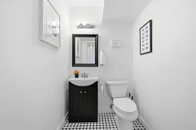 a white bathroom with a toilet and a sink at Beautiful 4th Floor Walk-Up Apartment in Old City in Philadelphia