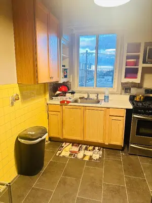 a kitchen with a sink and a trash can at Big Mama's House in Paterson