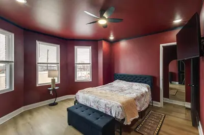 a bedroom with a bed and a ceiling fan at Colorful and Convenient Darby Apt, 7 Mi to Stadiums! in Darby
