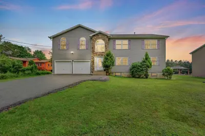a large house with a garage in a yard at Sleeps 12 Fire Pit Game Room Near Camelback in Long Pond