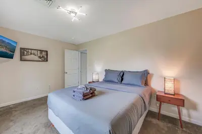a bedroom with a large bed and a nightstand and a bed sidx sidx sidx at Sleeps 12 Fire Pit Game Room Near Camelback in Long Pond