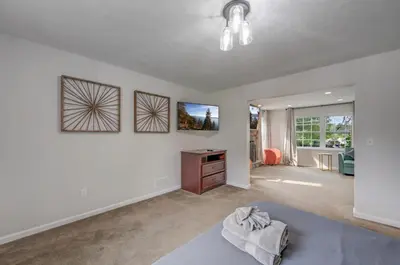 a living room with white walls and a table at Sleeps 12 Fire Pit Game Room Near Camelback in Long Pond