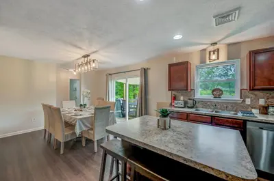 a kitchen and dining room with a table and a dining room at Sleeps 12 Fire Pit Game Room Near Camelback in Long Pond