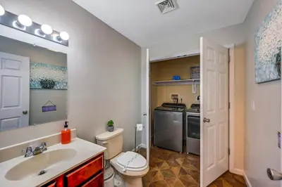 a bathroom with a sink and a toilet and a kitchen at Sleeps 12 Fire Pit Game Room Near Camelback in Long Pond
