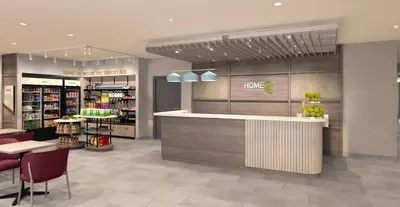 a store with a counter and chairs in a store at Home2 Suites By Hilton Burlington, Nj in Burlington