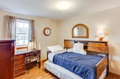 a bedroom with a bed and a desk and a window at Three Pines Family Retreat Home in Carlisle in Carlisle