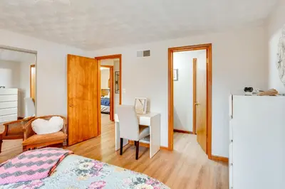 a bedroom with a bed and a desk with a chair at Three Pines Family Retreat Home in Carlisle in Carlisle