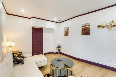 a living room with a couch and a table at 7 Mi to Philly Stadiums! Charming Apartment in Darby