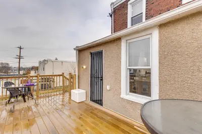 a balcony with a table and a glass table at 7 Mi to Philly Stadiums! Charming Apartment in Darby