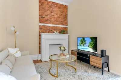 a living room with a white couch and a fireplace at Brooklyn Heights 2BR Secret Retreat in Brooklyn