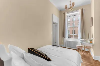 a bedroom with a bed and a desk and a window at Brooklyn Heights 2BR Secret Retreat in Brooklyn