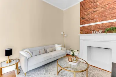 a living room with a couch and a fireplace at Brooklyn Heights 2BR Secret Retreat in Brooklyn