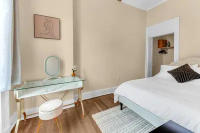 a bedroom with a bed and a desk with a mirror at Brooklyn Heights 2BR Secret Retreat in Brooklyn