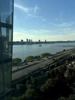 a view of a river and a bridge with a highway at Hudson River - Lincoln Center in New York