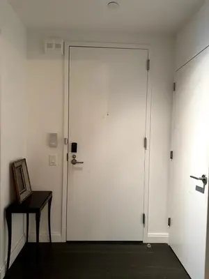 a large white door in a room with a table at Hudson River - Lincoln Center in New York