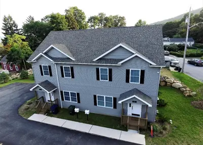 a gray house with a driveway in front of it at Luxury Townhouse Near West Point in Highland Falls