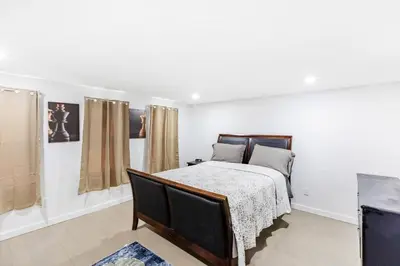 a bedroom with a bed and a tv in it at Orange NJ 2BR Duplex | Walk to Train + 2BA in Orange
