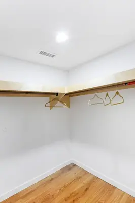 a table in a room with white walls and wooden floors at Orange NJ 2BR Duplex | Walk to Train + 2BA in Orange