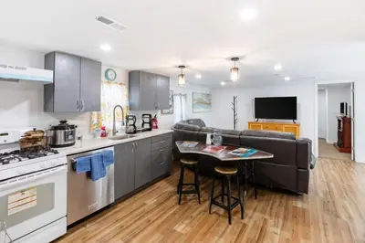 a kitchen and living room with a couch and a table at Orange NJ 2BR Duplex | Walk to Train + 2BA in Orange