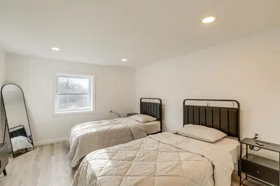 a bedroom with two beds and a window at Home with Lake Views and Deck in New Jersey Highlands! in Stanhope