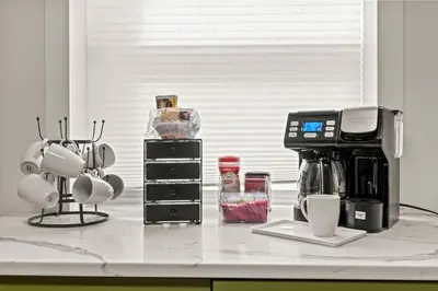 a kitchen counter with a coffee maker and cups at 3BR Gem in Graduate Hospital in Philadelphia