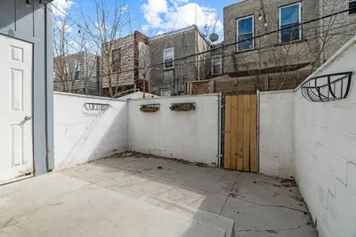 a white fence with a gate in front of a building at 3BR Gem in Graduate Hospital in Philadelphia