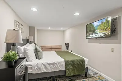 a bedroom with a bed and a tv on the wall at 3BR Gem in Graduate Hospital in Philadelphia