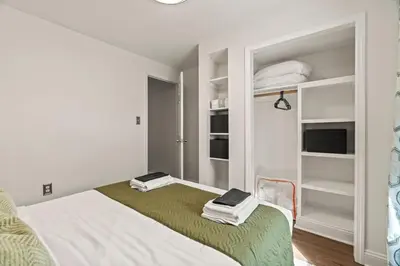 a white room with a bed and shelves at 3BR Gem in Graduate Hospital in Philadelphia