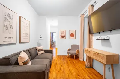 a living room with a couch and a television at 2-Bedroom Apartment in Hells Kitchen - Manhattan! in New York