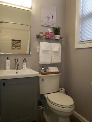 a bathroom with a toilet and a sink and a mirror at Attractive and Cozy Apartment - 4 bdrms 2 bths in Paterson