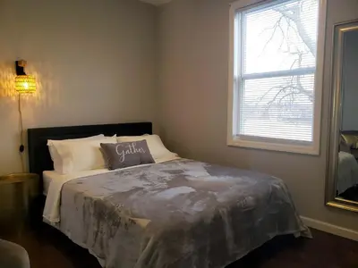 a bedroom with a bed with a pillow on it at Attractive and Cozy Apartment - 4 bdrms 2 bths in Paterson