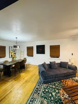 a living room with a couch and a table at Staten Luxe, Modern Stay Close to NJ, NYC and Brooklyn! in Arlington