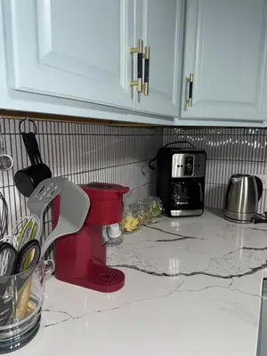 a kitchen counter with a sink and a microwave at Staten Luxe, Modern Stay Close to NJ, NYC and Brooklyn! in Arlington