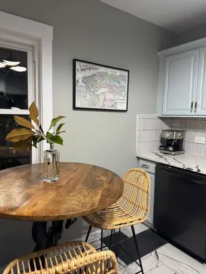 a kitchen with a wooden table and two chairs at Staten Luxe, Modern Stay Close to NJ, NYC and Brooklyn! in Arlington