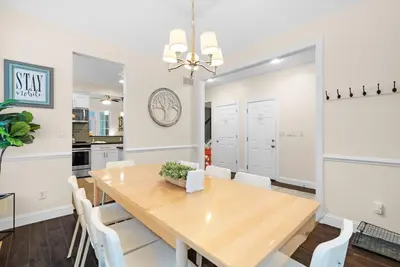 a dining room with a wooden table and white chairs at Hot Tub Game Room Spacious Close to Skiing in Albrightsville